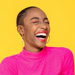 Gleeful woman smiling widely and brightly