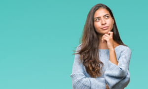 Woman in a questioning pose on a blue background